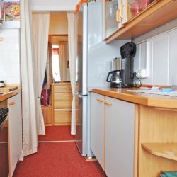 Colorfully decorated kitchen without threshold to the hallway