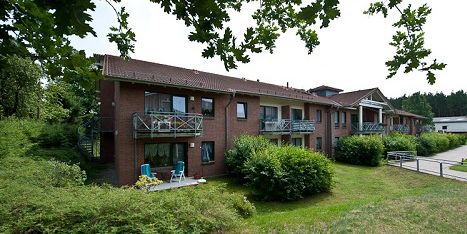 Cozy apartment complex with balconies and terraces on the edge of the forest