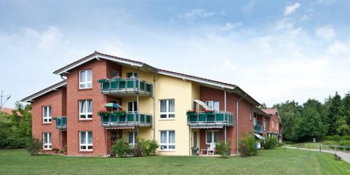 Large residential complex with balconies and green area